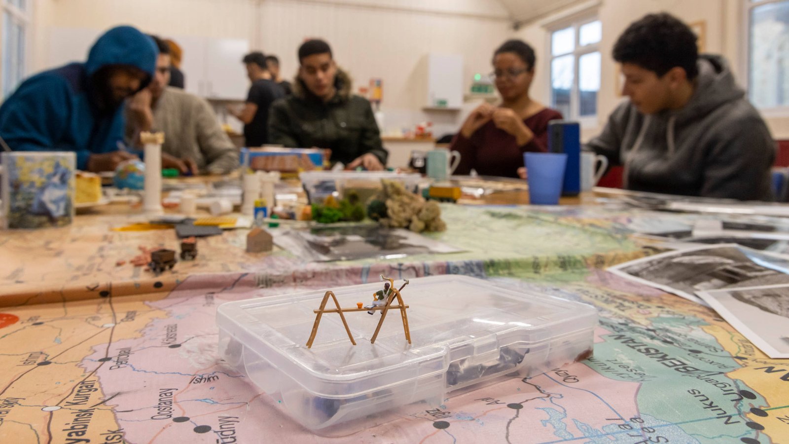 A group of multi-ethnic young people participate in a creative group workshop.