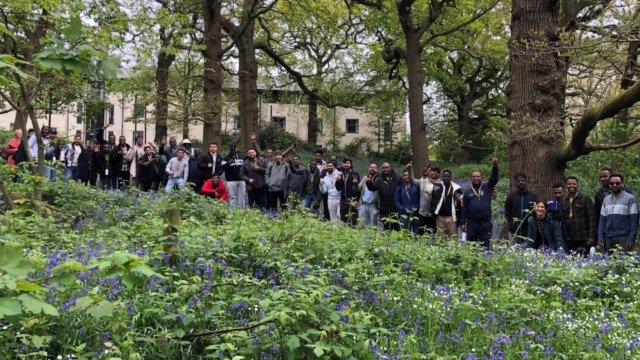 Napier residents group smile and wave at the camera whilst standing in Kent Community Oasis Garden.