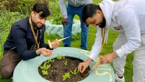 Napier residents plant bulbs in a plant pot in Kent Community Oasis Garden.