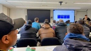 Napier residents are seated in a classroom watching a presentation by the University of Kent about UK Levels of Education.